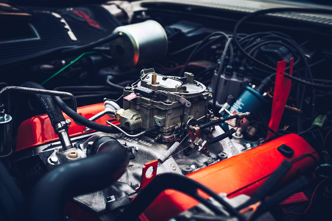 Translucent coolant expansion tank in a car engine bay with visible MIN and MAX markings on the side