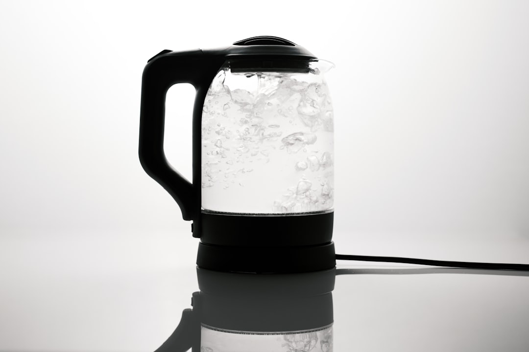 Interior of an electric kettle showing white limescale build-up on the heating plate