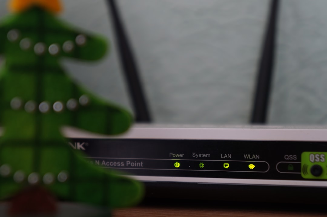 Home Wi-Fi router with vertical antennas placed on a wooden shelf, indicator lights showing active connections